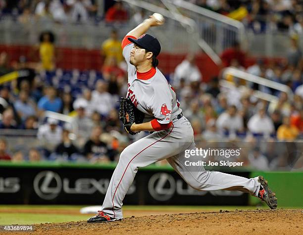 Relief pitcher Junichi Tazawa of the Boston Red Sox throws in the ninth inning against the Miami Marlins at Marlins Park on August 11, 2015 in Miami,...