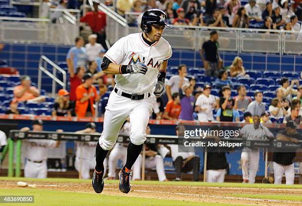 Ichiro Suzuki of the Miami Marlins runs to first after hitting a ninth inning single against the Boston Red Sox at Marlins Park on August 11, 2015 in...