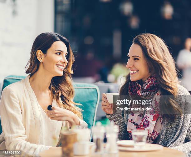 girls gossiping at outdoors cafe in istanbul - female with friend in coffee stock pictures, royalty-free photos & images