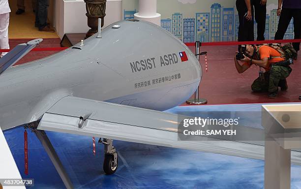 Photographer takes photo of the latest home made MALE Unmanned Aircraft Systems during a press conference of the 2015 Taipei Aerospace and Defense...