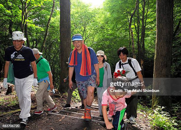 Family members of the crashed Japan Airlines 123 climb the Mount Osutaka on the 30th anniversary of the crash on August 12, 2015 in Ueno, Gunma,...