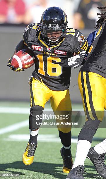 Brandon Banks of the Hamilton Tiger-Cats runs with the ball against the Winnipeg Blue Bombers during a CFL football game at Tim Hortons Field on...