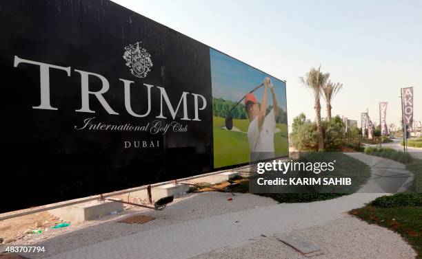 Real-estate magnate Donald Trump is seen playing golf on a billboard at the Trump International Golf Club Dubai in the United Arab Emirates on August...