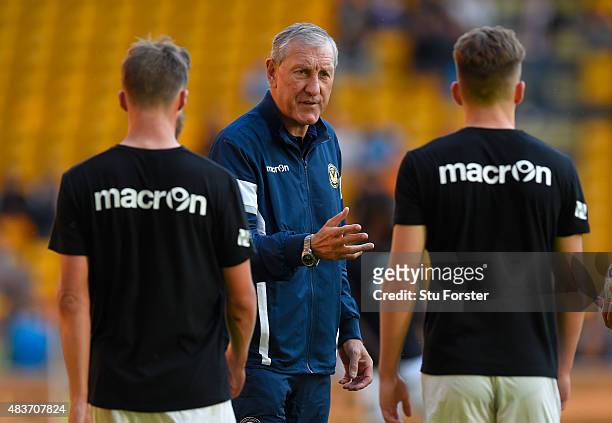 Newport manager Terry Butcher talks with his defenders before the Capital One Cup First Round match between Wolverhampton Wanderers and Newport...