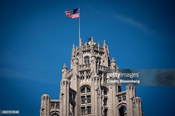 An American flag flies atop the Tribune Tower in Chicago, Illinois, U.S., on Friday, Aug. 7, 2015. Tribune Media Co. Is scheduled to report...