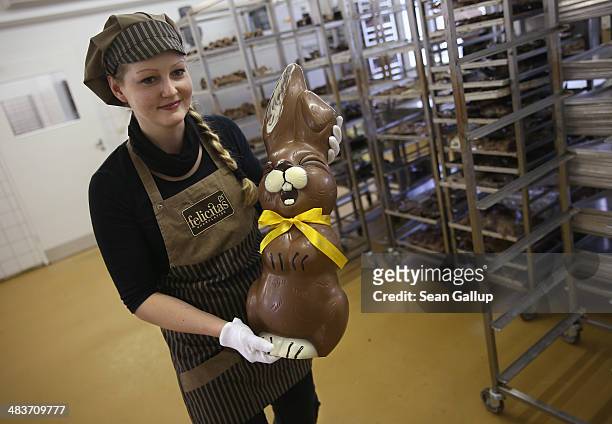 Employee Sandra Jaeckel carries a giant chocolate Easter bunny through the production facility at Confiserie Felicitas chocolates maker on April 9,...