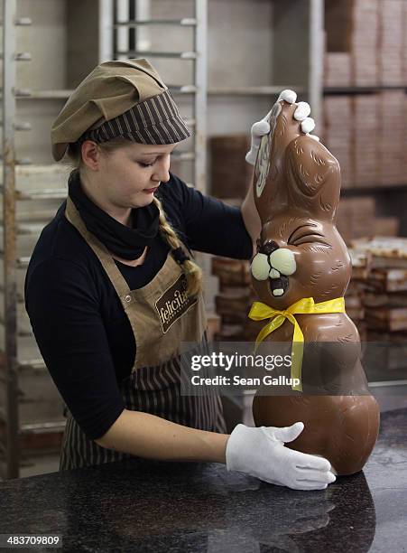 Employee Sandra Jaeckel, who had brought in a giant chocolate Easter bunny at the photographer's request, prepares to carry it away at the production...