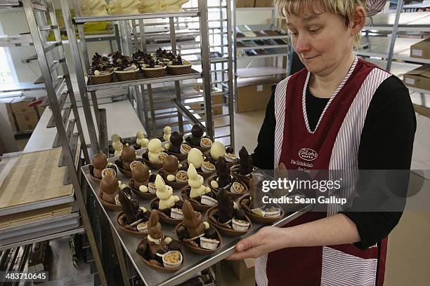 Employee Doreen Krohe prepares to pack chocolate Easter bunnies and eggs at the production facility at Confiserie Felicitas chocolates maker on April...