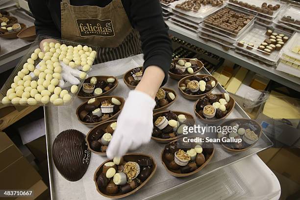 Employee Ramona Boehm packs chocolate Easter eggs at the production facility at Confiserie Felicitas chocolates maker on April 9, 2014 in Hornow,...