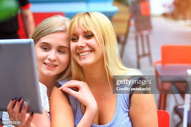 friends interacting with a tablet in a coffee shop - knez mihailova street stock pictures, royalty-free photos & images