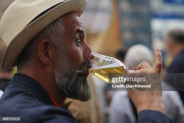 Man drinks a glass of Ale at the CAMRA Great British Beer festival at Olympia London exhibition centre on August 12, 2015 in London, England. The...