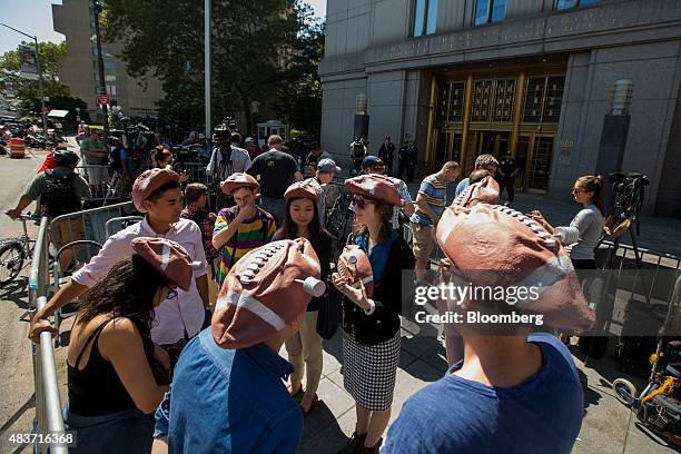 Group of people wearing "Deflategate" hats wait outside federal court during a conference meeting between New England Patriots quarterback Tom Brady,...