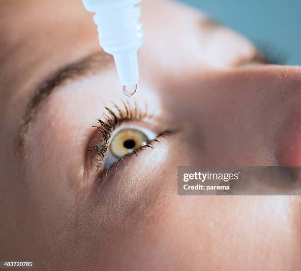 eyedropper releasing fluid into an eye - dry eye stock pictures, royalty-free photos & images