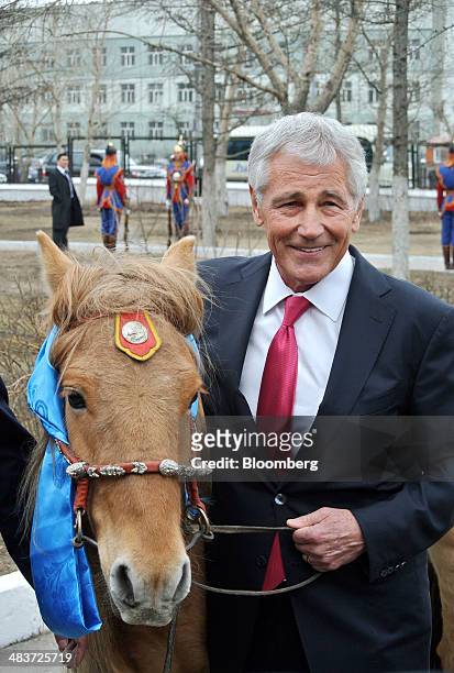 Chuck Hagel, U.S. Secretary of defense, receives a horse gifted to him during a visit to Ulaanbaatar, Mongolia, on Thursday, April 10, 2014. Hagel,...