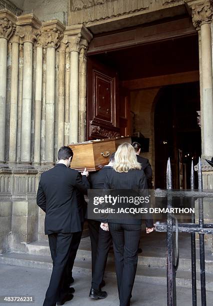People carry the coffin of French author Regine Desforges during her funeral on April 10, 2014 in Paris. Regine Desforges, an author, editor,...