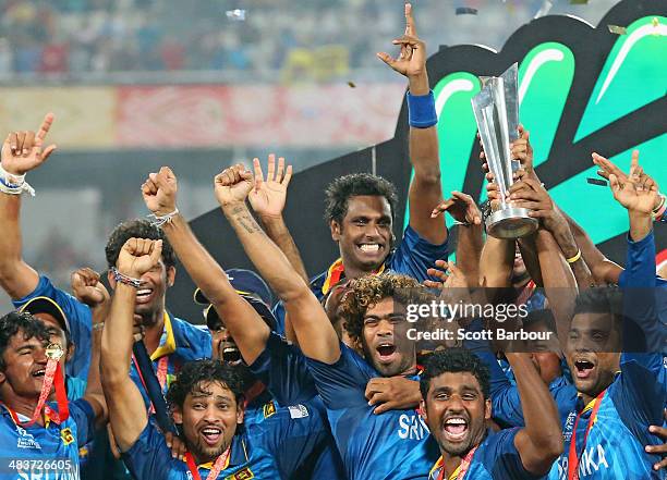 Lasith Malinga of Sri Lanka and his team celebrate with the trophy on the podium after winning the Final of the ICC World Twenty20 Bangladesh 2014...