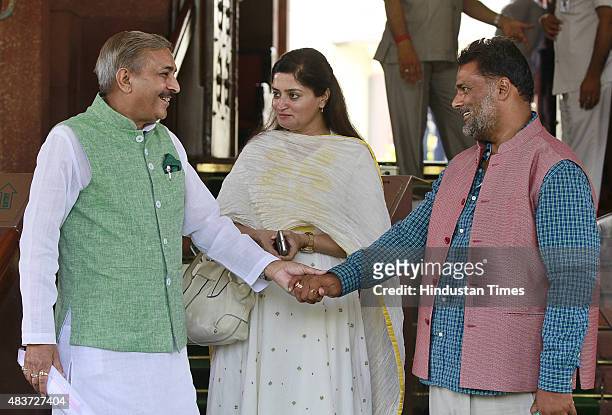 Congress leader Pramod Tiwari, BJP MP Poonamben Madam and Pappu Yadav during the monsoon session at Parliament House, on August 12, 2015 in New...
