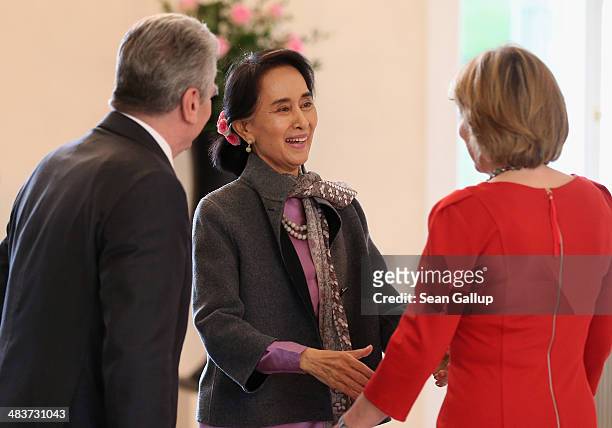 Myanmar human rights activist and politician Aung San Suu Kyi greets German President Joachim Gauck and First Lady Daniela Schadt upon her arrvial at...