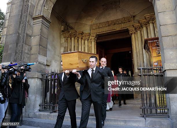 Funeral services' employees carry the coffin of French author Regine Desforges after her funeral ceremony on April 10, 2014 in Paris. Regine...
