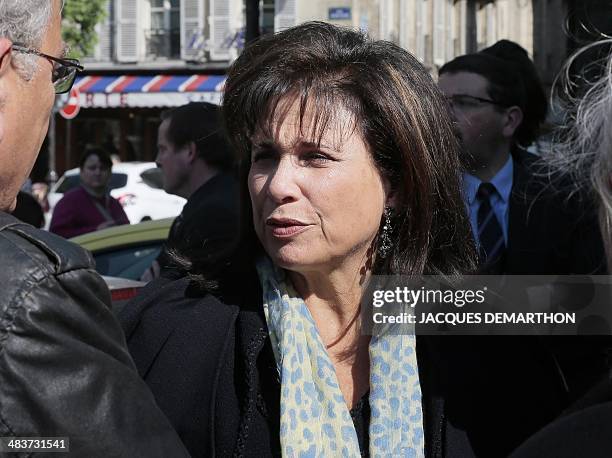French journalist's Anne Sinclair leaves the church after attending French author Regine Desforges's funeral on April 10, 2014 in Paris. Regine...