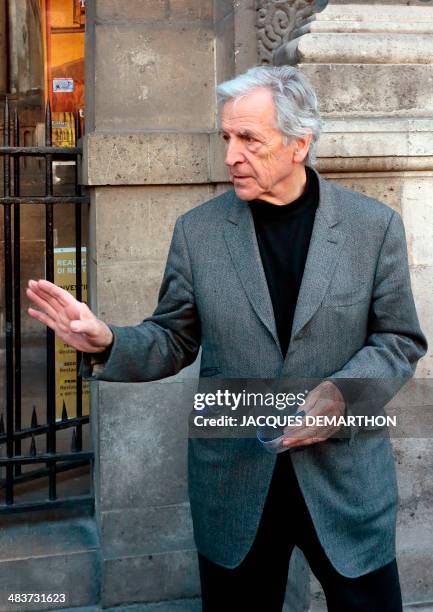 Greek-born French filmmaker Costa-Gavras gestures while leaving the church after attending French author Regine Deforges's funeral on April 10, 2014...