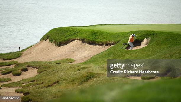 George Coetzee of South Africa hits out of the bunkers during a practice round prior to the 2015 PGA Championship at Whistling Straits on August 12,...