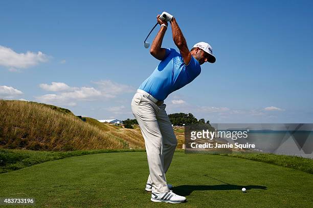 Dustin Johnson of the United States hits a tee shot during a practice round prior to the 2015 PGA Championship at Whistling Straits on August 12,...