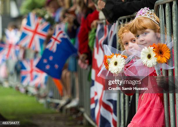 Two girls wait to see Catherine, Duchess of Cambridge and Prince William, Duke of Cambridge attend a wreathlaying service at the War Memorial in...