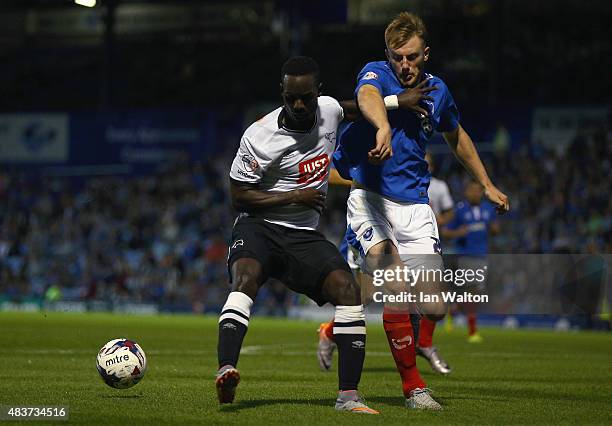 Matt Clarke of Portsmouth tries to tackle Simon Dawkins of Derby County during the Capital One Cup First Round match between Portsmouth v Derby...