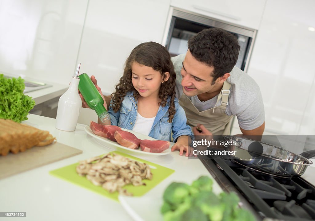 Father cooking at home with his daughter