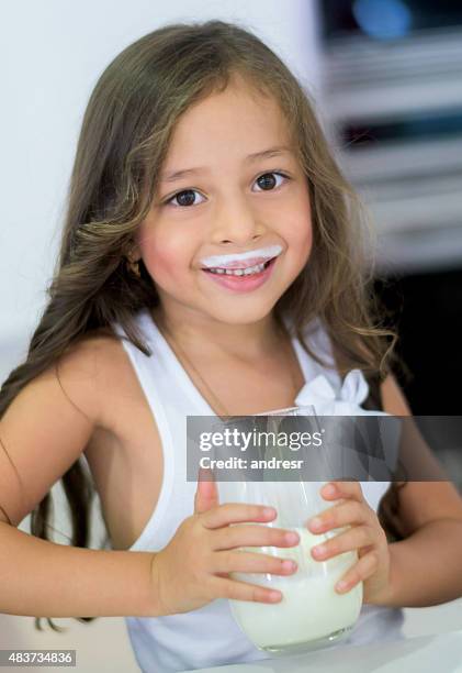 girl drinking a glass of milk - smiling lips stock pictures, royalty-free photos & images