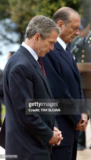 President George W. Bush and French President Jacques Chirac pray during wreath-laying services at the World War II Normandy American Cemetary as...