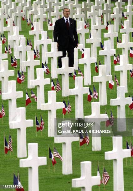 President George W. Bush walks through the World War II Normandy American Cemetary on his way to deliver a speech as part of US Memorial Day...
