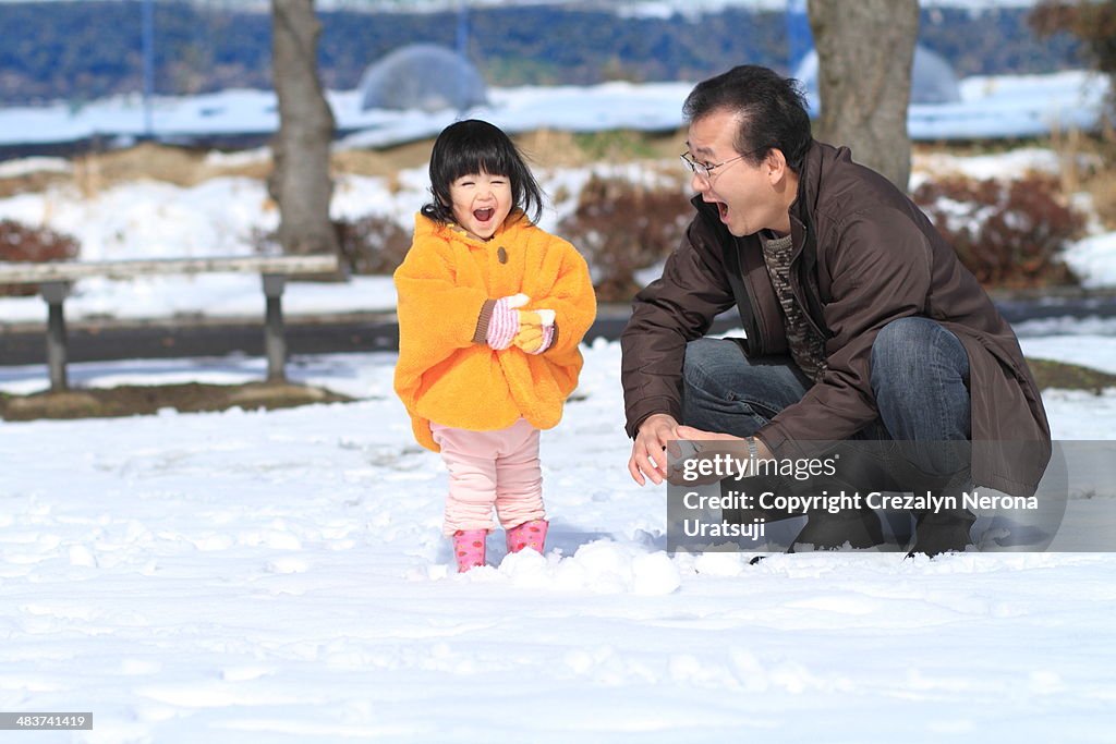 Father and Child with Snow