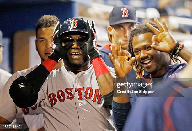 David Ortiz of the Boston Red Sox looks with teammate Hanley Ramirez to the spot where his second inning solo home run landed in the stands during...