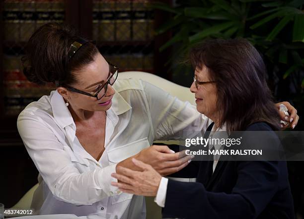 Former actress Eden Tirl who is one of three new alleged sexual assault victims of comedian Bill Cosby consoles Linda Ridgeway Whitedeer during a...