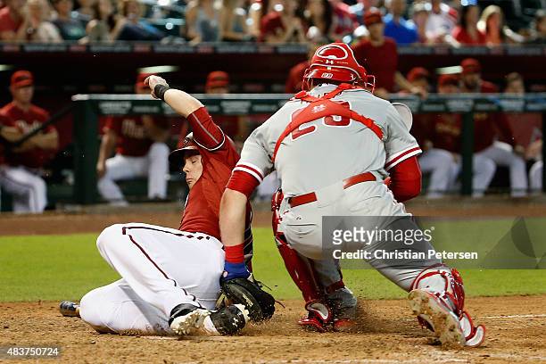 Chris Owings of the Arizona Diamondbacks is tagged out at home-plate by catcher Cameron Rupp of the Philadelphia Phillies during the eighth inning of...
