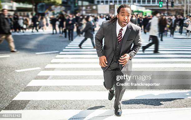 afro american business running in shibuya , tokyo - businessman running stock pictures, royalty-free photos & images