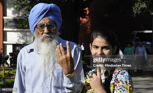 First time voter with her grandfather showing their inked finger after casting her vote at Government Model Senior Secondary School Sec-18 on April...