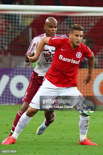 Rafael Moura of Internacional battles for the ball against Marlon Santos of Fluminense during the match between Internacional and Fluminense as part...