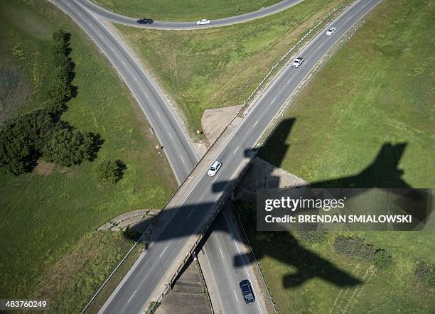 The shadow of Air Force One is seen as US President Barack Obama arrives at Austin-Bergstrom International Airport April 10, 2014 in Austin, Texas....