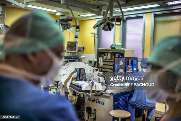 Surgeon sitting in front of screens of a Focal One device performs a robot-assisted prostate tumorectomy using ultrasound imaging on April 10, 2014...