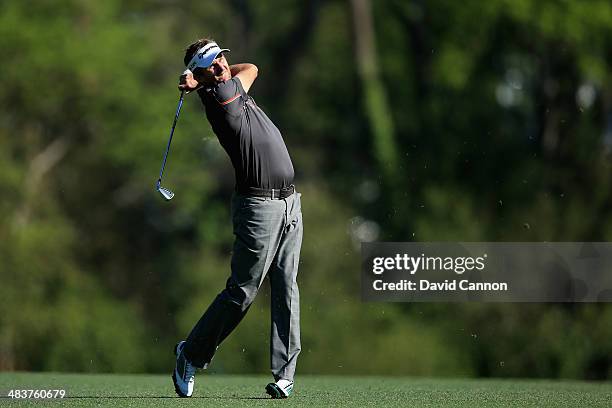 David Lynn of England hits his approach shot on fifth hole during the first round of the 2014 Masters Tournament at Augusta National Golf Club on...