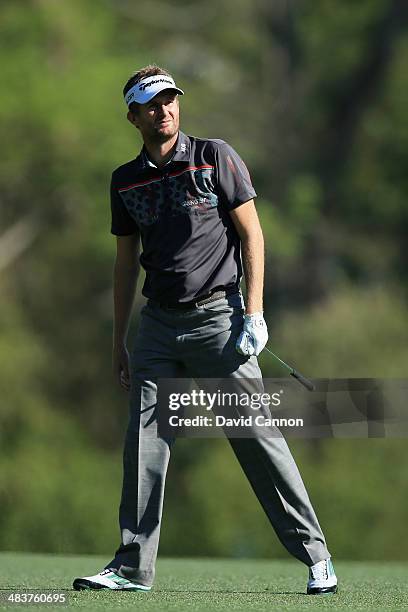 David Lynn of England watches his approach shot on fifth hole during the first round of the 2014 Masters Tournament at Augusta National Golf Club on...