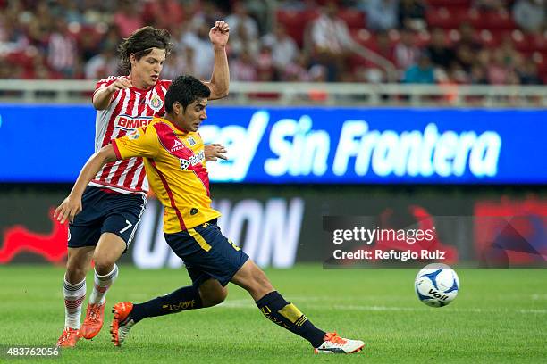 Carlos Fierro of Chivas fights for the ball with Enrique Perez of Morelia during a 4th round match between Chivas and Morelia as part of the Apertura...