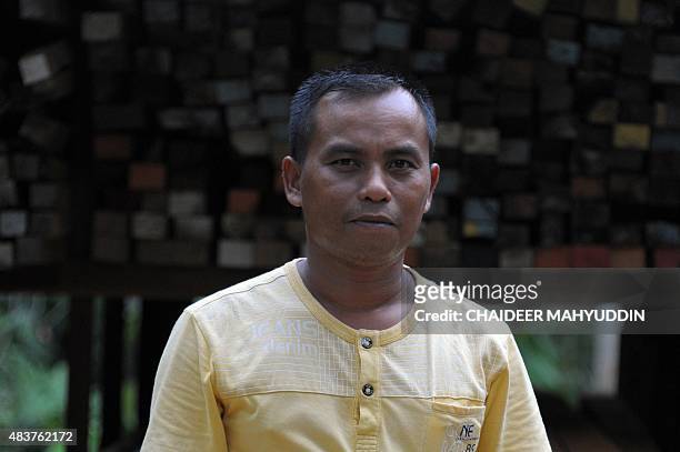 To go with Indonesia-unrest-Aceh,FOCUS by Nurdin Hasan In this photograph taken on August 12 former Free Aceh Movement rebel Nazaruddin is...
