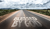 Blessed By God written on rural road