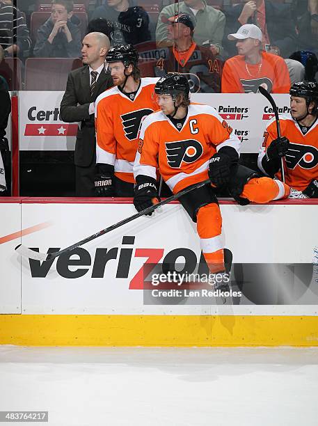 Assistant Coach Ian Laperriere, Sean Couturier, Claude Giroux and Jay Rosehill of the Philadelphia Flyers react in the first period of their game...