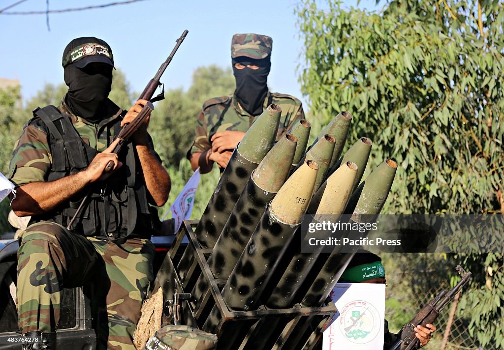 Masked Palestinian gunmen from Ezzedine al-Qassam brigades,...