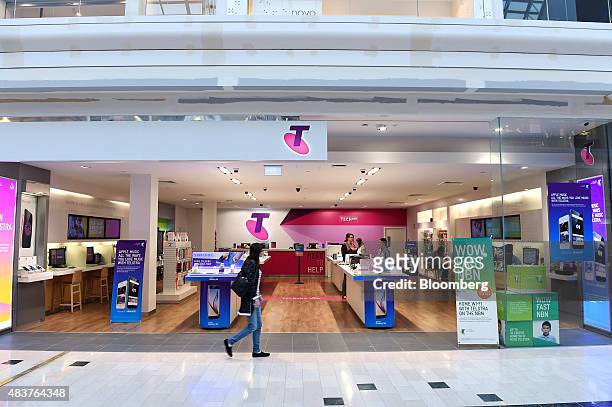 Customer walks past a Telstra Corp. Retail store in Melbourne, Australia, on Thursday, Aug. 13, 2015. Telstra posted profit that met analysts'...